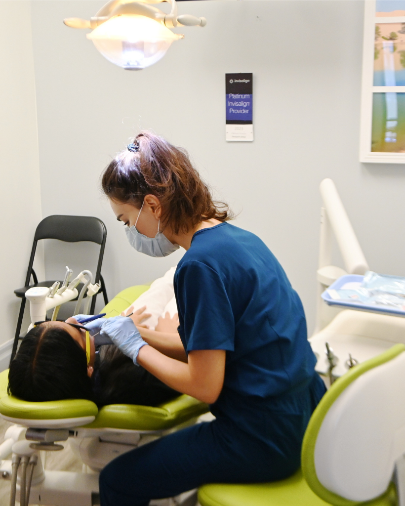 A dentist attending to her patient during an appointment.